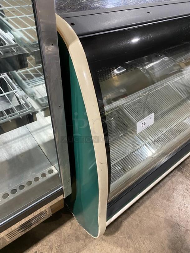 Carrier Tyler Series refrigerated butcher deli display with curved glass, adjustable stainless shelving, rear sliding doors.