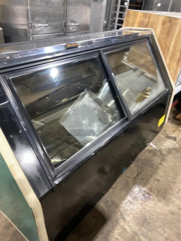 Carrier Tyler Series refrigerated display case with curved glass, adjustable stainless steel shelving, double sliding glass doors.