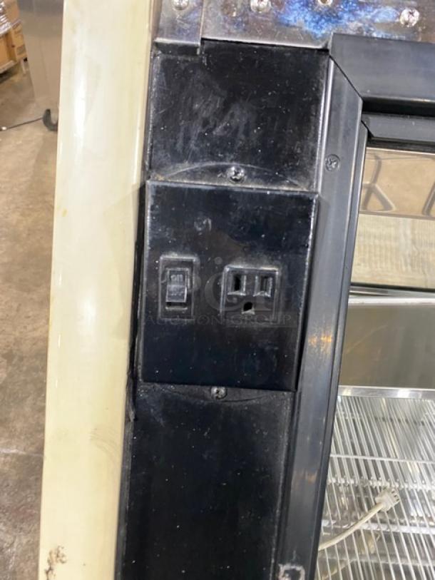 Carrier Tyler Series curved glass refrigerated display with adjustable stainless steel shelving and rear access sliding door.