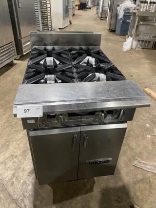 Vulcan stainless steel 4-burner natural gas range with backsplash, enclosed cabinet base, and legs; excellent condition.