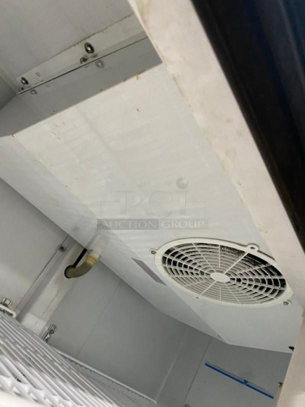 Maxx Cold MXM248RS commercial refrigerator interior view, showing fan unit and wire racks, 115V, white finish, on casters.