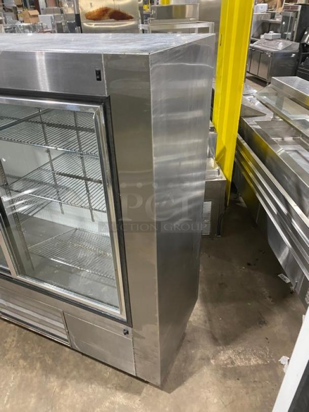 Leader LS72SC stainless steel merchandiser refrigerator, double sliding glass doors, chrome wire racks, on casters.