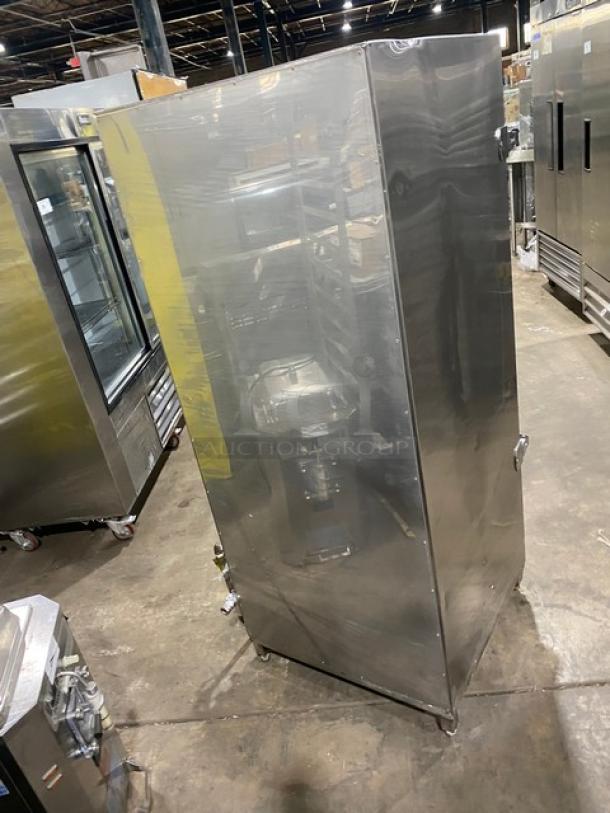 Commercial stainless steel natural gas smoker oven on legs, full-size. Scratches evident, industrial setting, right-side door handle.