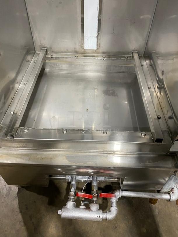 Commercial stainless steel smoker oven, natural gas powered, free-standing, with legs; visible gas connection, clean interior.