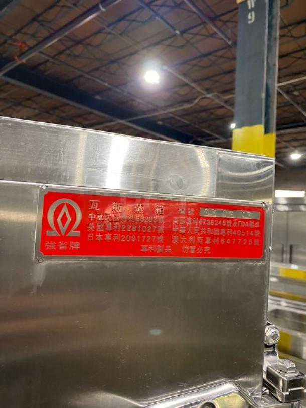 Stainless steel natural gas-powered smokehouse oven, on legs, with red manufacturer label, commercial use.