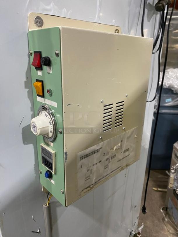 Commercial stainless steel natural gas smokehouse oven, freestanding with legs. Features temperature dial, control panel.