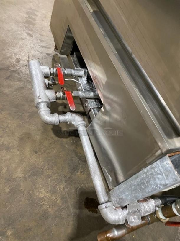 Commercial stainless steel smokehouse oven, natural gas-powered, full-size, on legs; visible piping with red valves.