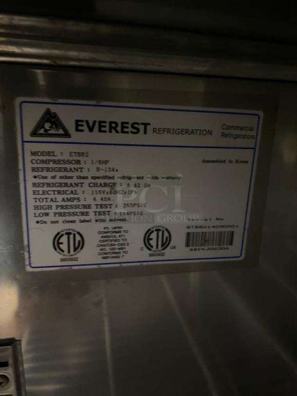 Everest stainless steel 2-door undercounter worktop refrigerator, model ETBR2. Features poly-coated wire racks, 115V, on casters.