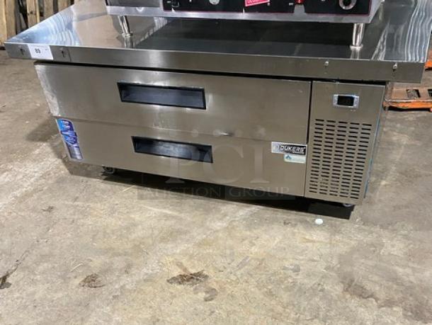 Duker's commercial stainless steel 2-drawer refrigerated chef base with oversized worktop, SN: DUK22100423040000, on casters.