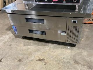 Duker's commercial stainless steel 2-drawer refrigerated chef base with oversized worktop, SN: DUK22100423040000, on casters.