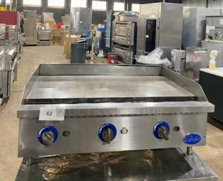 Globe stainless steel natural gas countertop flat griddle with back and side splash, on legs, in used condition.