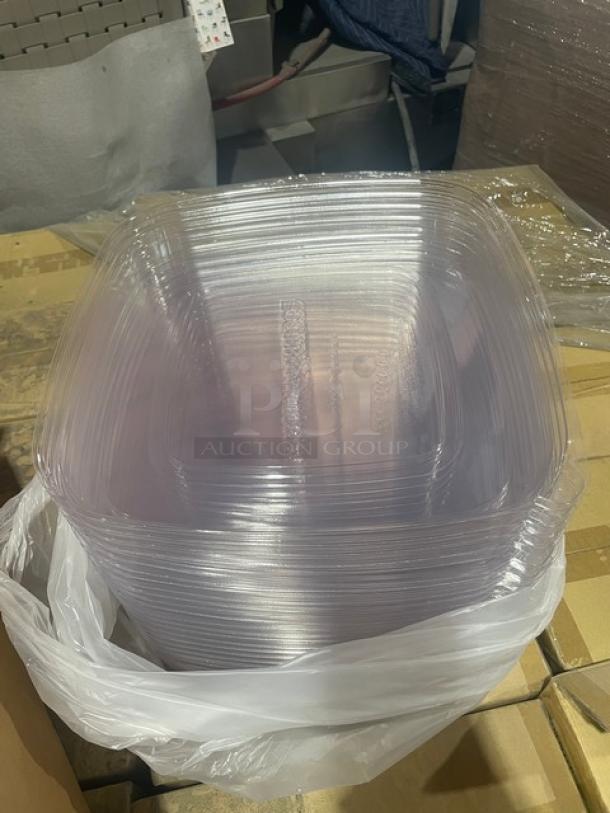 Stack of clear plastic bowl lids, model EP-BL160LID, in new condition, inside a white plastic bag on cardboard pallets.