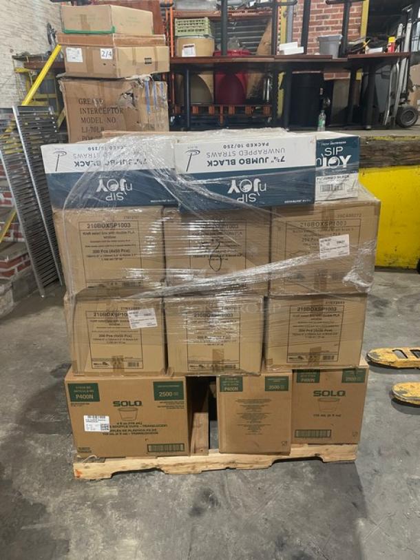 Mixed pallet of new commercial items, including Crystal Ware straws, Pack N’Wood containers, Dart Solo cups, LBP trays, and Quantum Storage shelves, wrapped and labeled for auction.