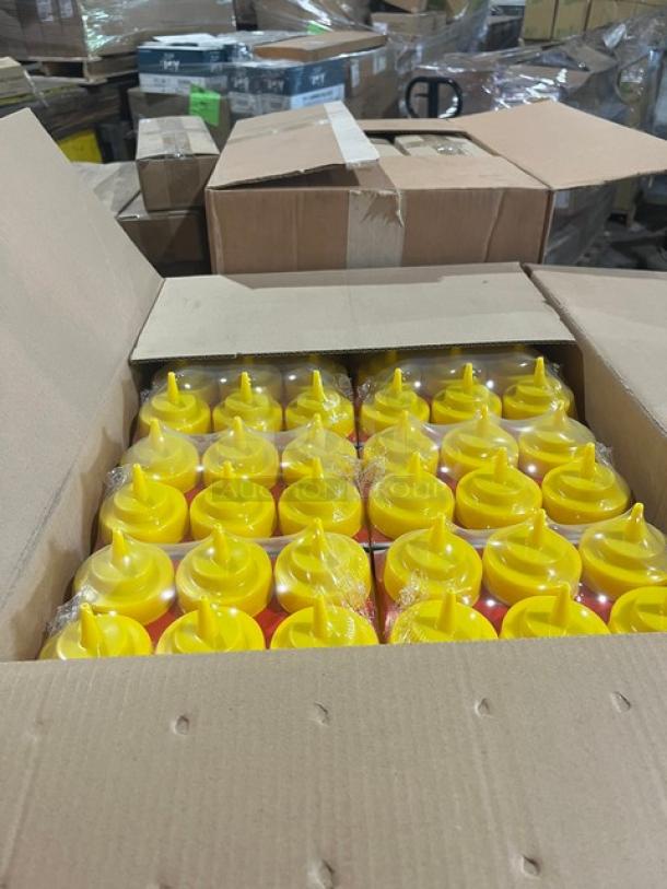 Box of Winco yellow 16 oz. squeeze bottles, model PSW-16Y, in new condition within a mixed pallet.