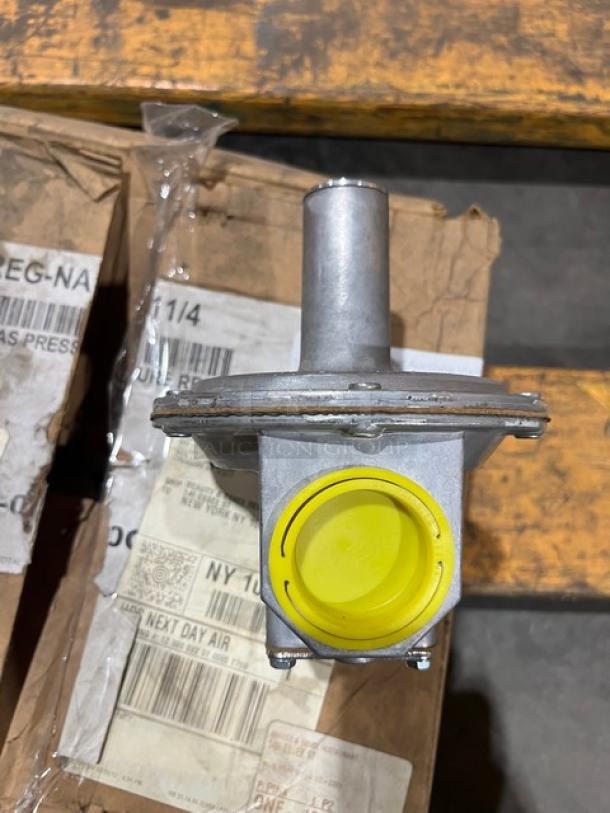 Brand new Vulcan 1-1/4" gas pressure regulator, Model PRESREGNA114, showing yellow cap and packaging.