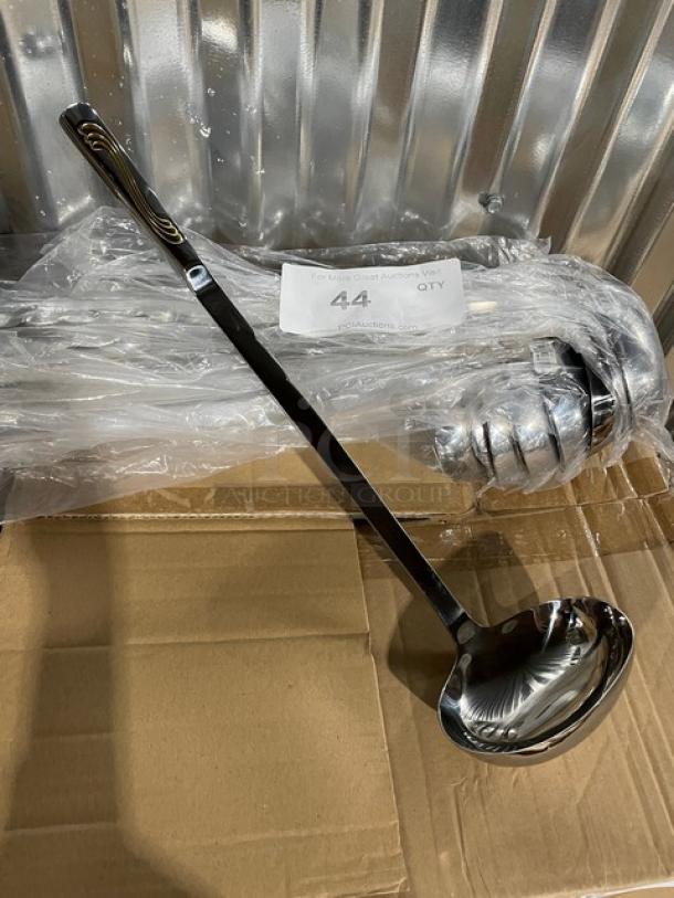 Brand new Vollrath Windway Series 6 oz. oval ladle, stainless steel, model 46653, with golden decal handle.