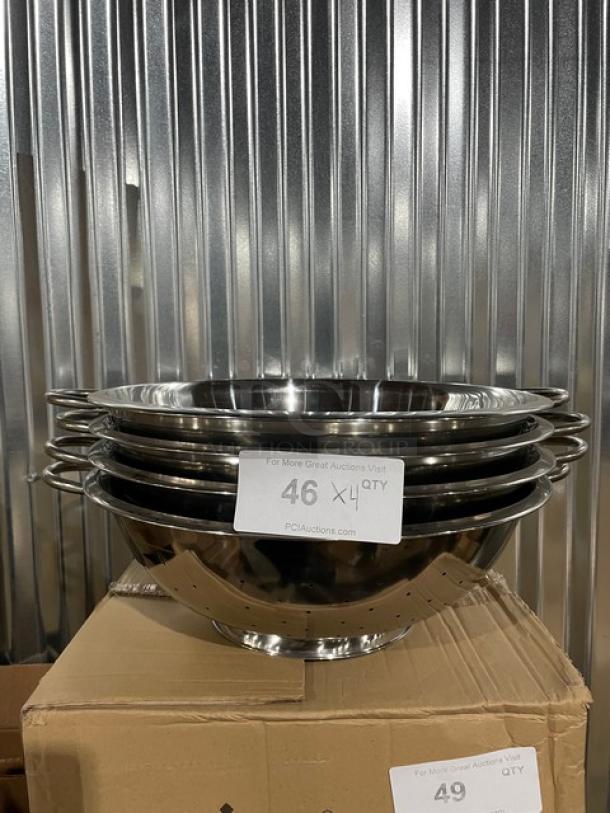 Brand new Winco 14 Qt. stainless steel perforated colander, model COD14, with handles. Four colanders stacked together.