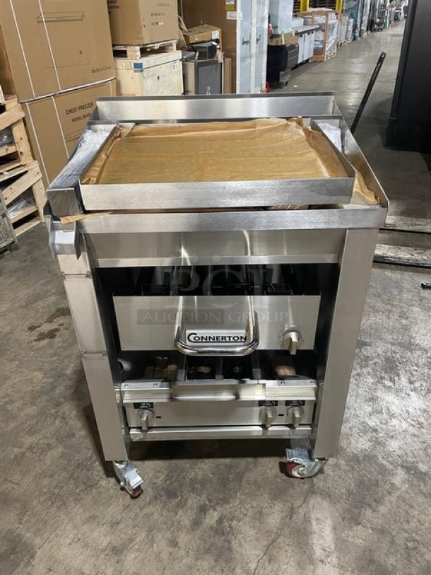Brand new Connerton A-1F stainless steel gas griddle/broiler combo on casters. Model SN: 127027A23. Highly polished finish.