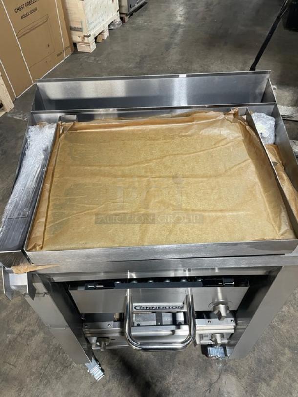 Brand new Connerton A1F stainless steel griddle/overfire broiler combo. Highly polished, on casters, natural gas powered.