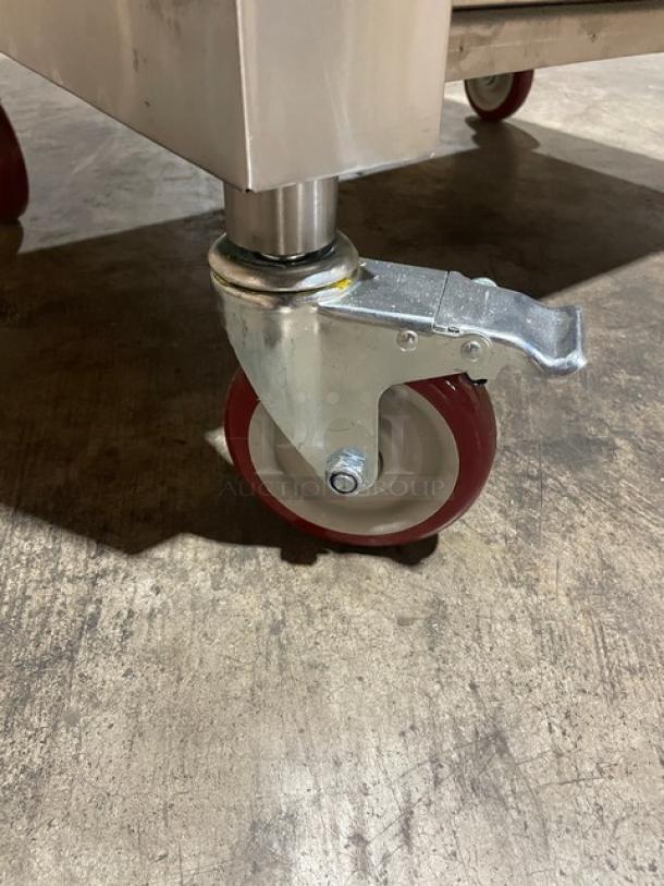 Brand new Connerton A1F stainless steel griddle/broiler on sturdy caster wheels, natural gas powered, model SN: 127027A23.