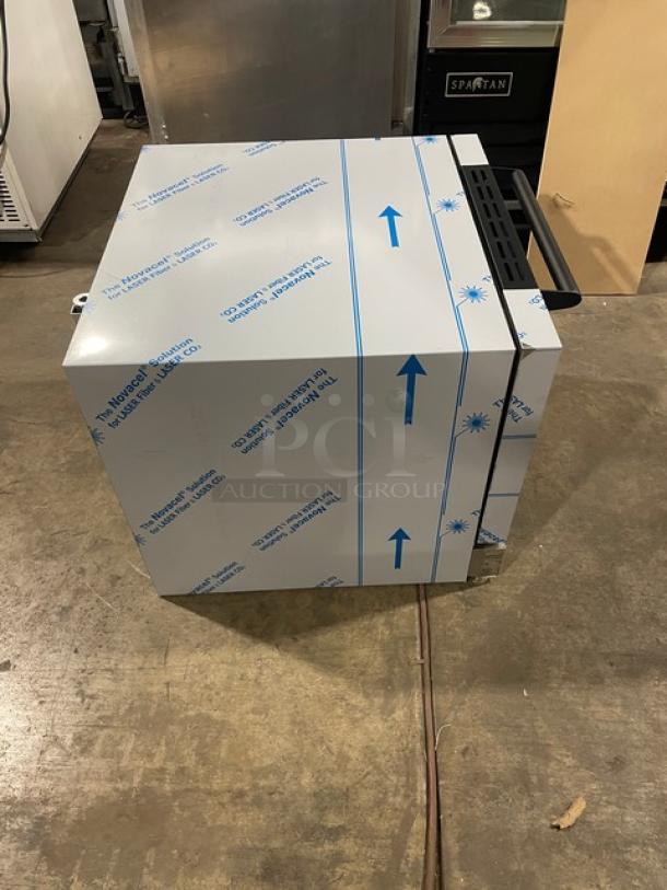 BRAND NEW Moffat TurboFan E23D3 stainless steel countertop convection oven with wire racks, protective wrap, model and serial number visible.