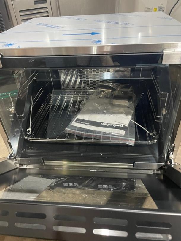 Brand new Moffat TurboFan E23D3 convection oven, stainless steel, with wire racks, 208V, 1 phase, countertop model with legs.