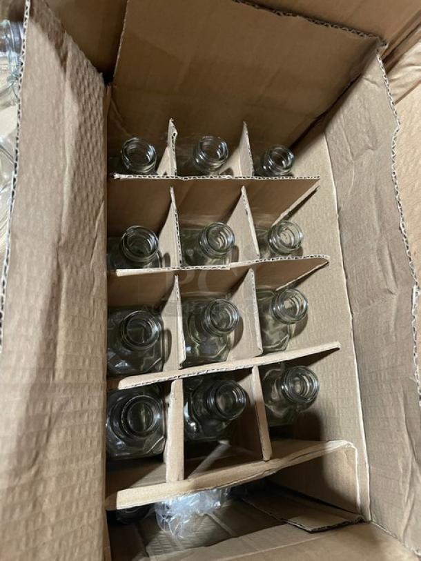 Box of clear glass oil/vinegar cruets, model G-104, 6 oz each, in cardboard dividers; part of a mixed auction pallet.
