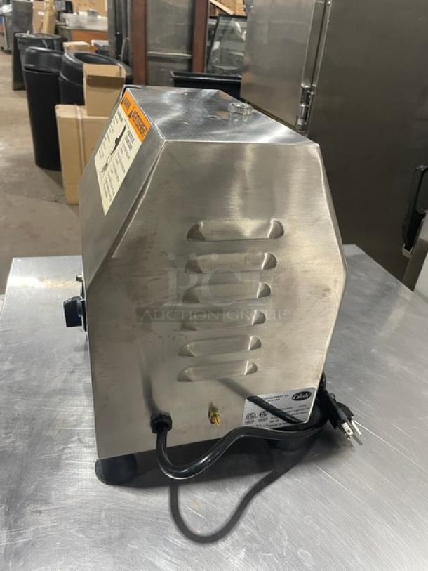Brand new Globe Chefmate CM12 meat chopper; stainless steel, electric-powered, 115V, on legs, serial 12210875.