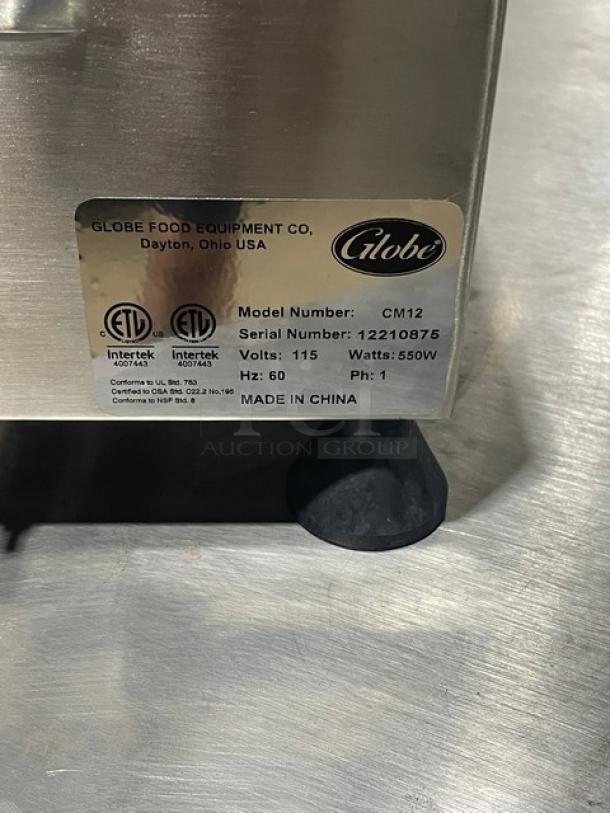 Globe CM12 meat chopper, stainless steel, brand new, 115V, 550W, serial number 12210875, on legs, made in China.