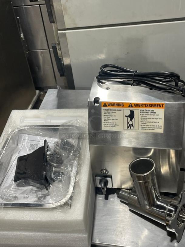 Brand new Globe CM12 Chefmate stainless steel meat chopper, 250 lb capacity. Includes electric cords, packaging, and warning labels visible.