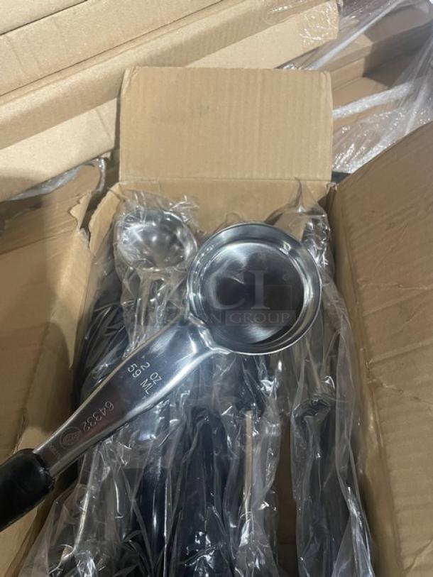 Brand new Vollrath 6433220 stainless steel 2 oz. spoodle; solid bowl, black grip handle, shown in packaging.