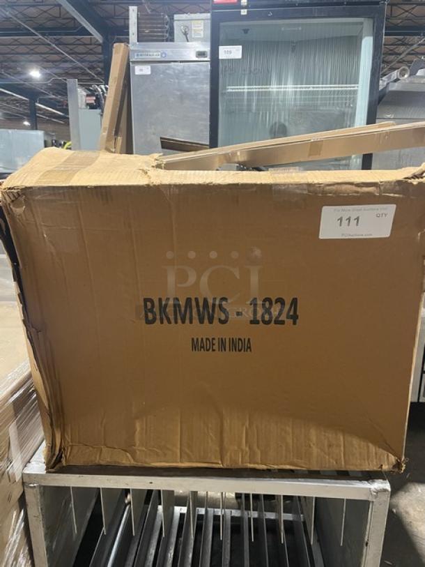 Box containing a BK Resources commercial stainless steel wall mount microwave shelf, model BKMWS1824, new but scratch-n-dent.