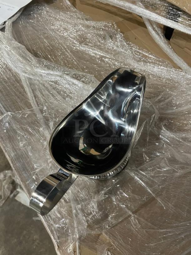 Brand new Vollrath stainless steel 8 oz. gravy boat, mirror shine finish, gadroon base, model 47578, in packaging.