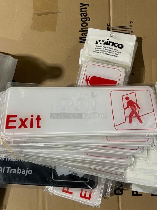 Brand new Winco model SGN-381W white "Exit" sign with red text and emergency icons, packaged in clear bag.
