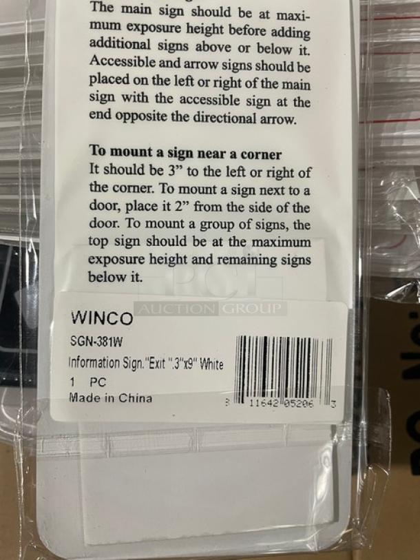 Brand new Winco SGN-381W commercial white "Exit" sign, 3"x9", in packaging with installation instructions visible.