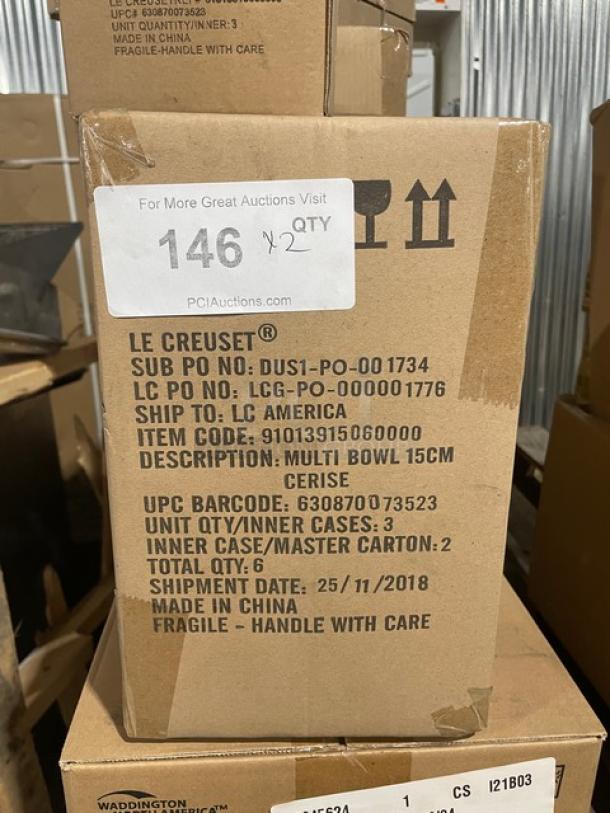 Alt text: Cardboard box labeled "Le Creuset Cerise Multi-Bowl," Model 91013915060000, 6" stoneware, 15cm, 20 oz, commercial red.