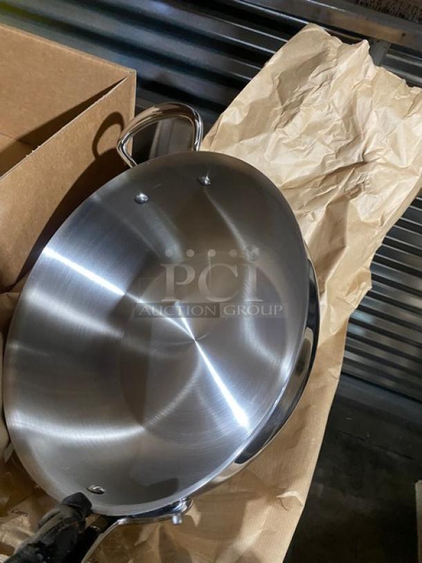 Brand new Mauviel 1830 M'Cook Series stainless steel splayed sauté pan, model 521228, with cast steel handles.