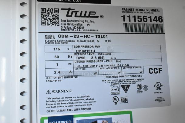 Brand new 2025 True GDM-23-HC cooler label, showing details like model, voltage, and refrigerant type.