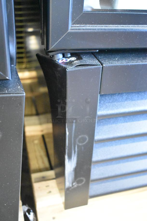 Brand new True GDM-23-HC single door cooler merchandiser, featuring metal construction, poly-coated racks, visible small dents.