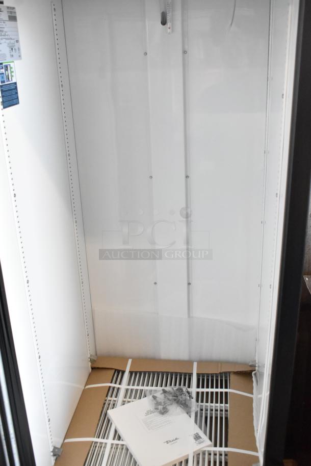 Brand new 2025 True GDM-23-HC single door cooler, with poly-coated racks, interior packaging, and visible labels; 115 volts, 1 phase.