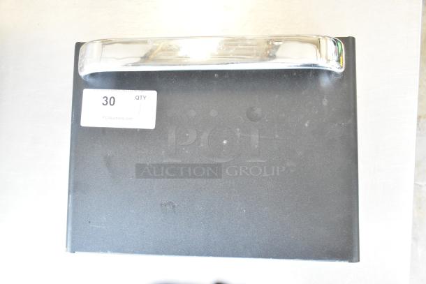 Brand new commercial metal door with visible handle, minor scratches, and attached label marked "30 QTY".