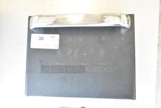 Brand new commercial metal door with visible handle, minor scratches, and attached label marked "30 QTY".