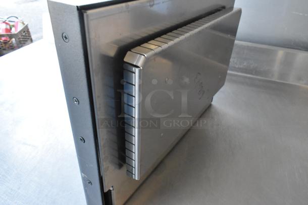 Brand new metal commercial door with visible scratch and dent; sturdy construction, sleek finish.