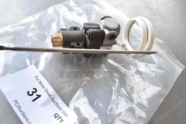 Brand new Robertshaw BJWA25PBD-03-24 gas thermostat, labeled "scratch and dent," in packaging with auction tag number 31.