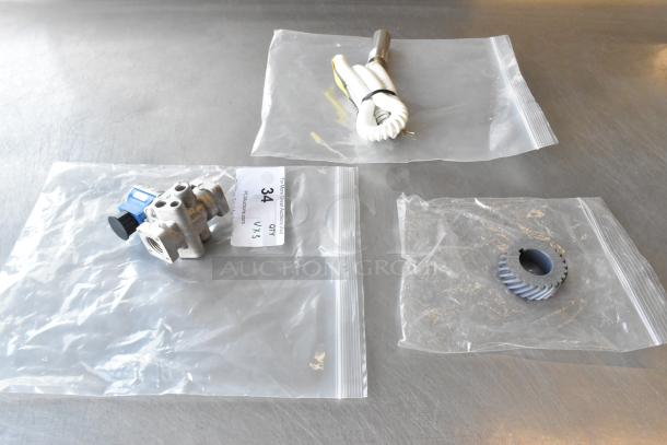 Three brand new scratch and dent items in clear bags, includes H91DA-13 unit, Manitowoc FSG cord. Quantity tag reads "34."