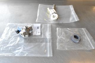 Three brand new scratch and dent items in clear bags, includes H91DA-13 unit, Manitowoc FSG cord. Quantity tag reads "34."