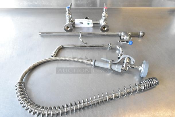 Brand new T&S faucet with dual handles and spray nozzle. Some minor scratches and dents. Includes flexible hose.