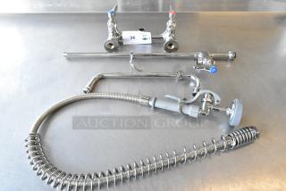 Brand new T&S faucet with dual handles and spray nozzle. Some minor scratches and dents. Includes flexible hose.