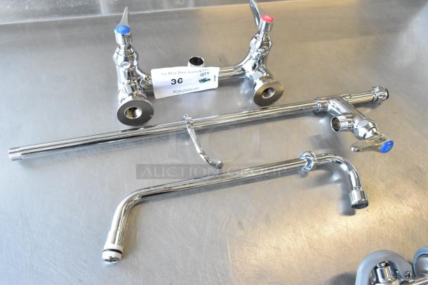 Brand new T&S faucet set with handles and spray nozzle, chrome finish, scratch and dent condition, includes blue and red lever handles.