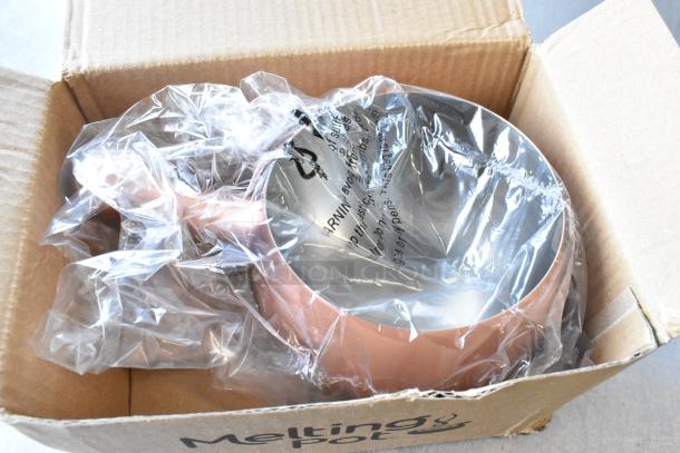 Cardboard box containing a brand new, sealed Melting Pot, slightly visible; labeled as "scratch and dent."